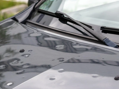 Hail damage on hood surface of car